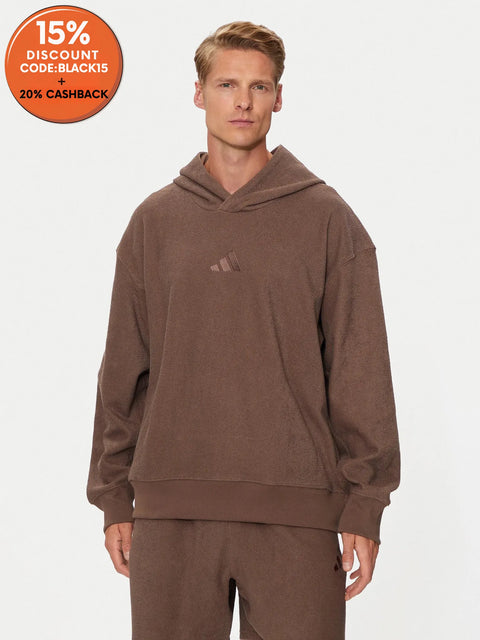 Man wearing a brown hoodie with a logo on a white background