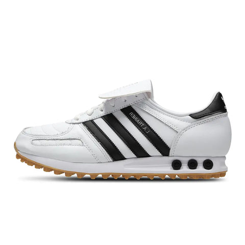 White sneaker with black stripes on a white background