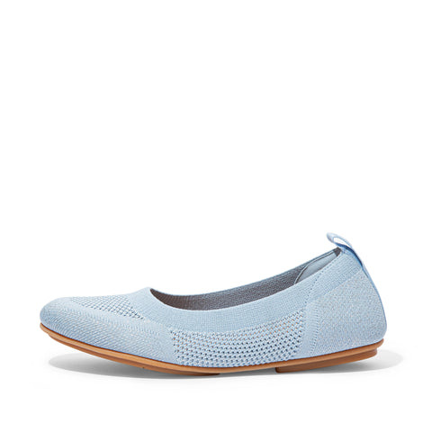 Light blue flat shoe with brown sole on a white background
