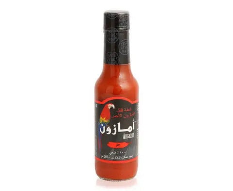 Bottle of Amazon hot sauce with a black label on a white background