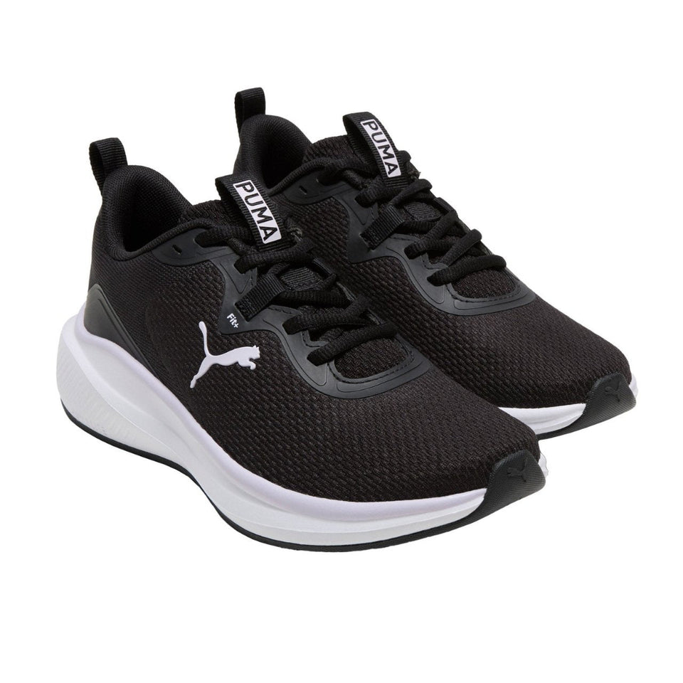 Black Puma sneakers on a white background