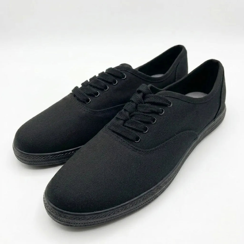 A pair of black canvas lace-up sneakers shown from a three-quarters angle on a clean white background.