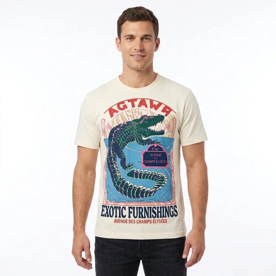 A man wearing a cream-colored graphic t-shirt with a blue and red alligator print and the text 'ACTAVE EXOTIC FURNISHINGS'.
