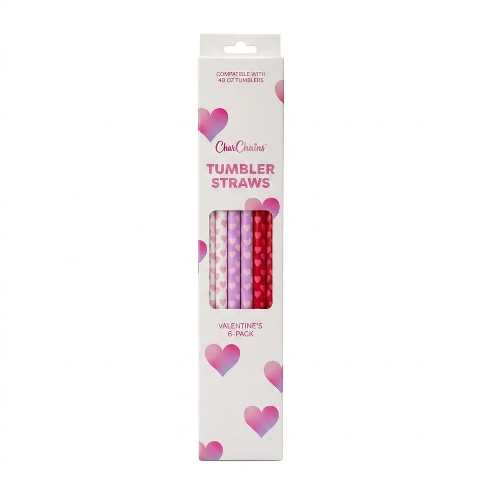 A boxed set of tumbler straws by OneCricketz, featuring a white package decorated with pink and purple hearts and a clear window showing four patterned straws in pink, purple, red, and dark red.