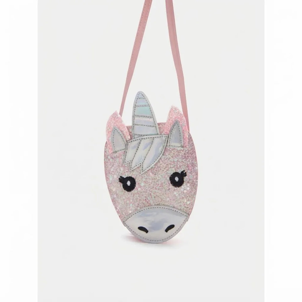 A pink glitter unicorn head crossbody bag with a silver horn, embroidered black eyes, and a light pink strap, shown against a plain light gray background.