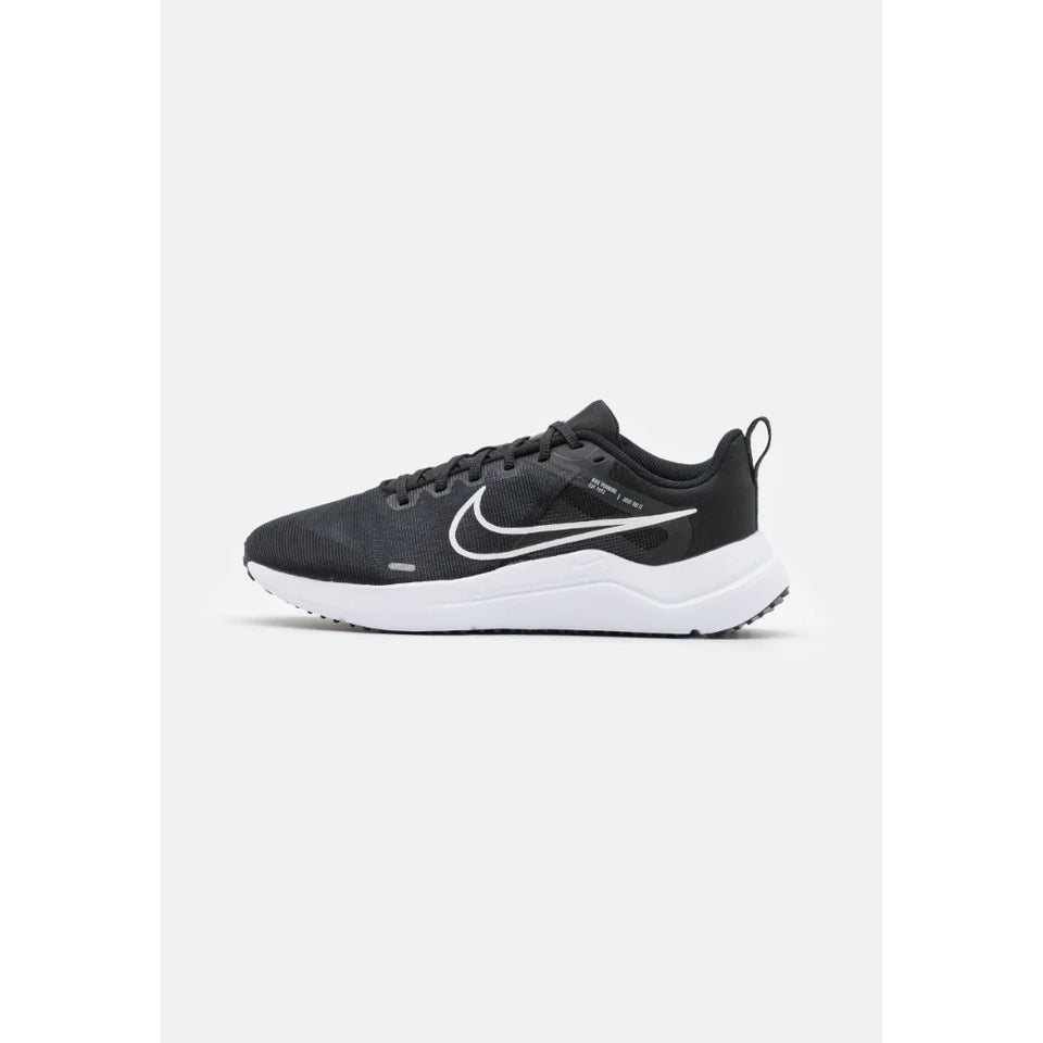 A black Nike running shoe with a white Swoosh logo and white midsole, shown in a side profile on a light gray background.