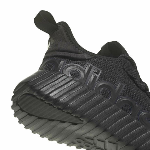 Black sneaker with textured sole and brand logo on a white background