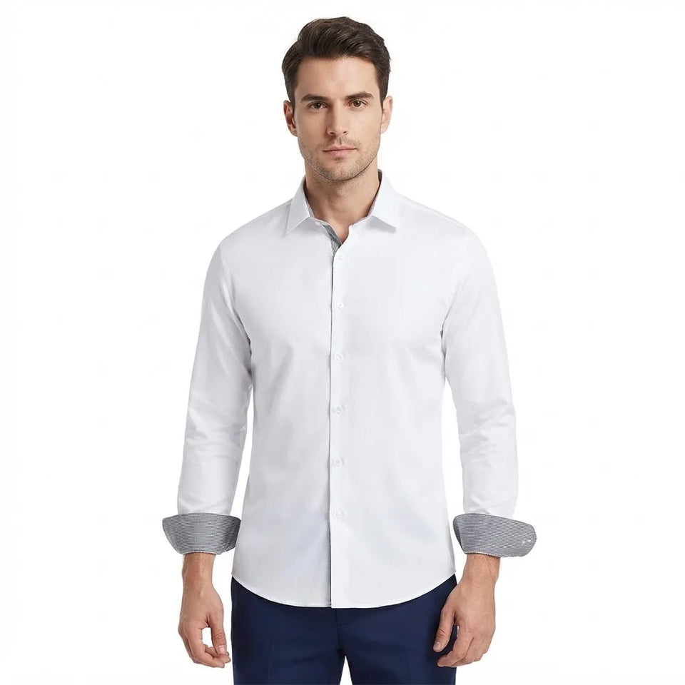 A man wearing a white long-sleeve button-down dress shirt with rolled-up sleeves showing a gray patterned lining, paired with navy pants, against a plain white background.