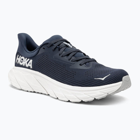 Navy running shoe with white sole on a light gray background