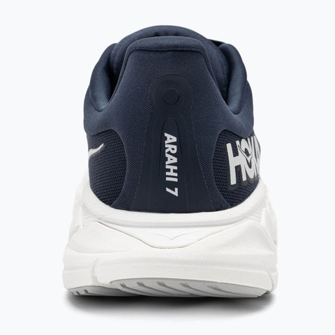 Navy running shoe with white sole on a white background