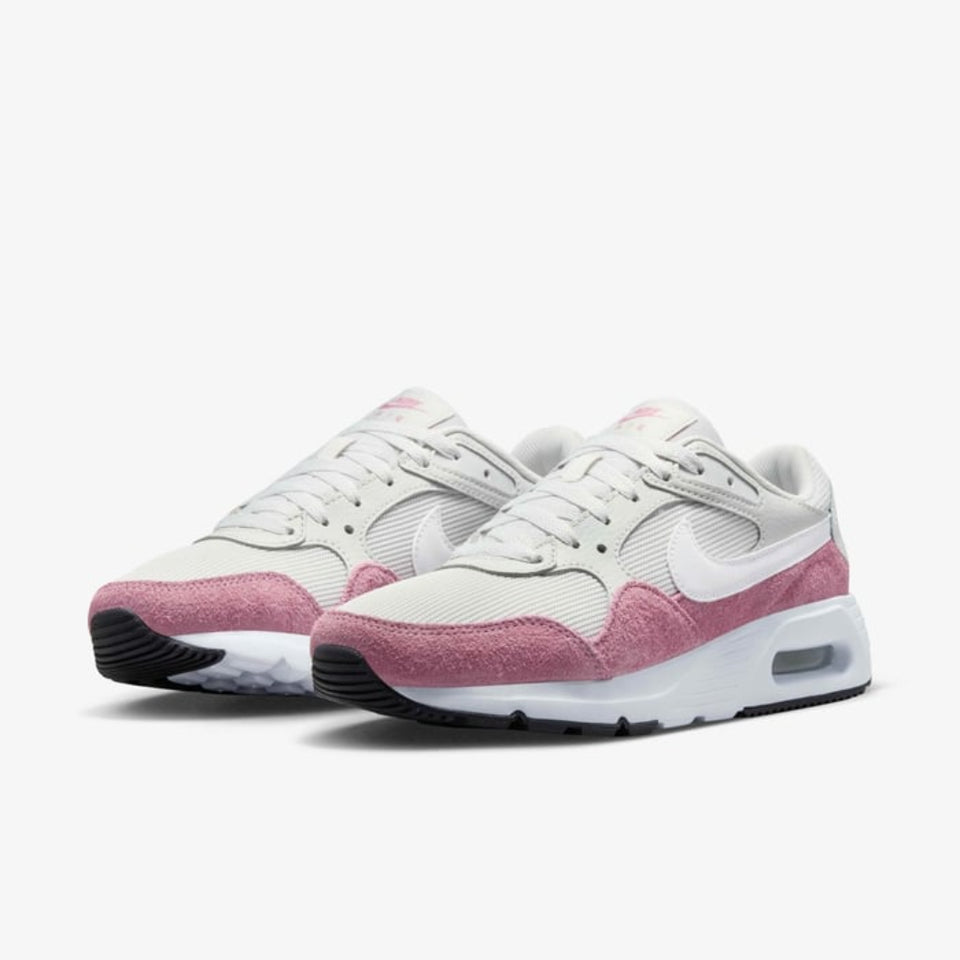 A pair of Nike Air Max 2013 sneakers in white and dusty pink, featuring a white mesh upper, pink suede overlays, a white Swoosh, and a white midsole with a visible air cushion unit.