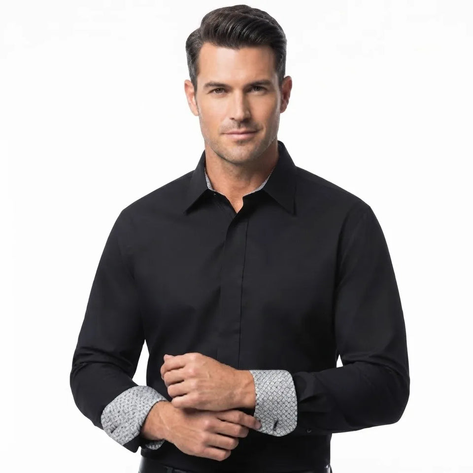 A man wearing a black long-sleeve dress shirt with patterned light gray and white cuffs, posed against a solid white background.