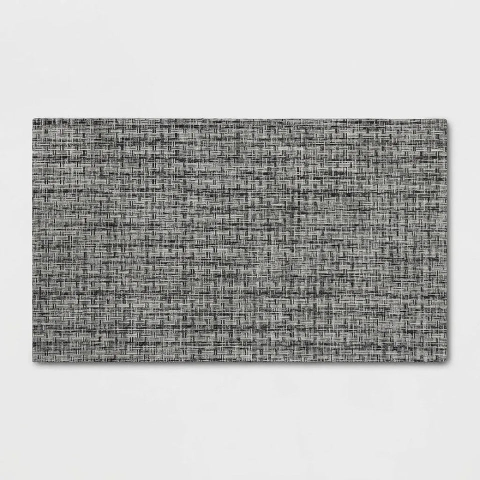 A rectangular gray woven placemat with a textured, linen-like pattern, shown flat against a light gray background.