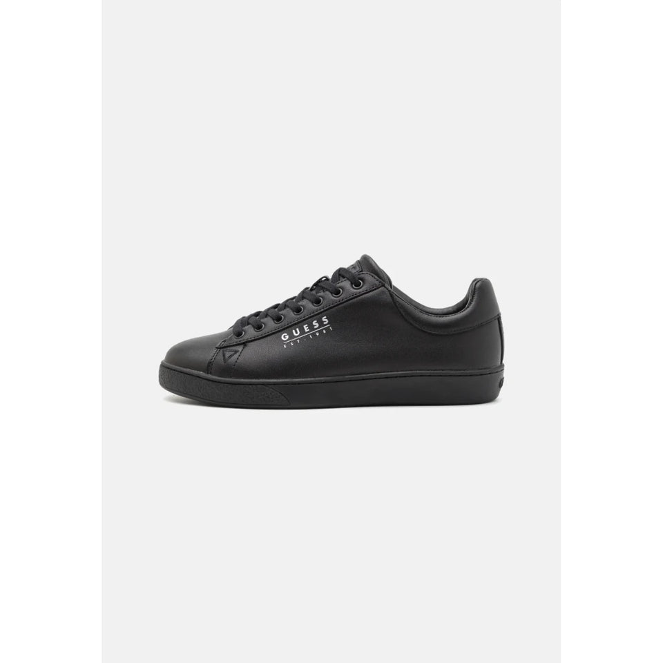 Black leather shoe on a light gray background