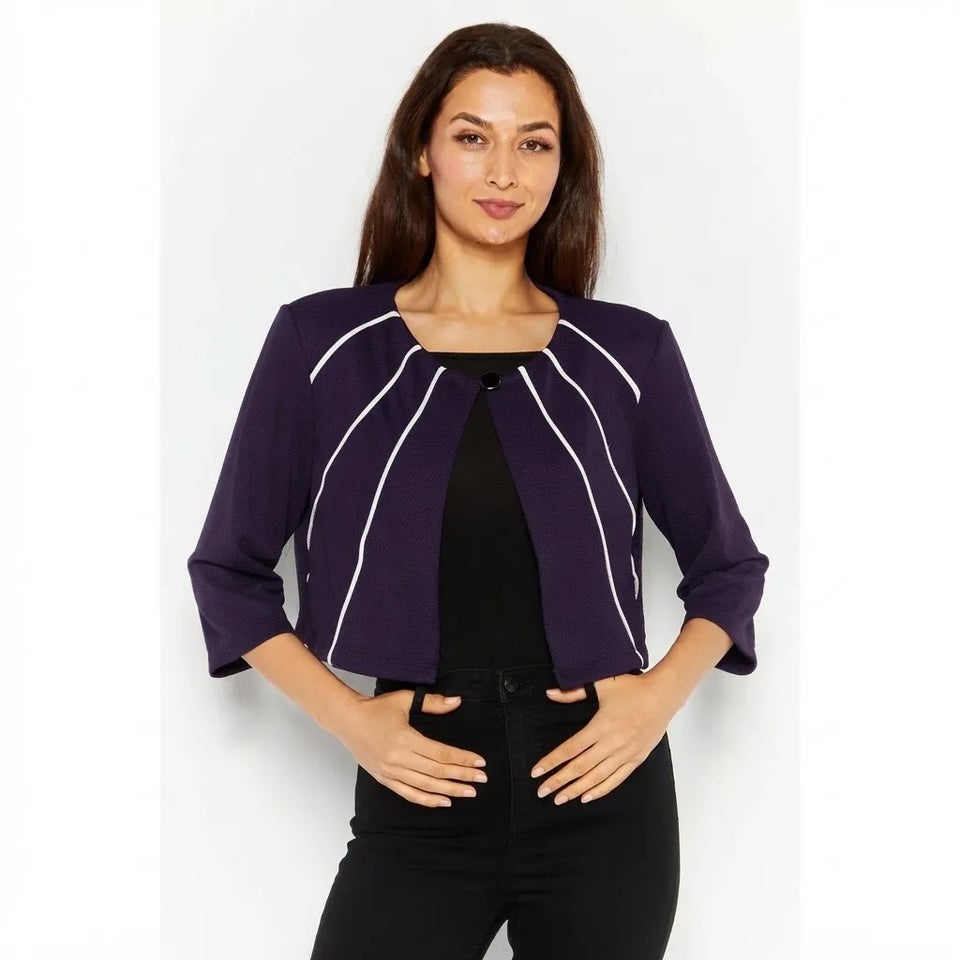 A woman modeling a cropped purple jacket with white vertical stripe details, worn over a black top and black pants against a light gray studio background.