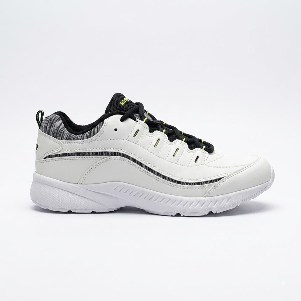A white low-top athletic sneaker with black laces, black textured side stripes, and a black and white patterned collar lining, shown from a side profile on a white studio background.