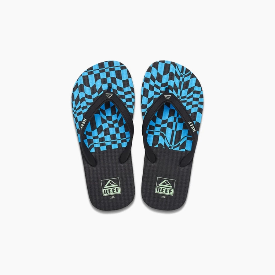 A pair of Reef brand flip-flops featuring a vibrant blue and black checkerboard pattern on the footbeds, with black straps and footbeds, set against a plain white background.