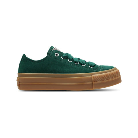 Green sneaker with brown sole on a white background