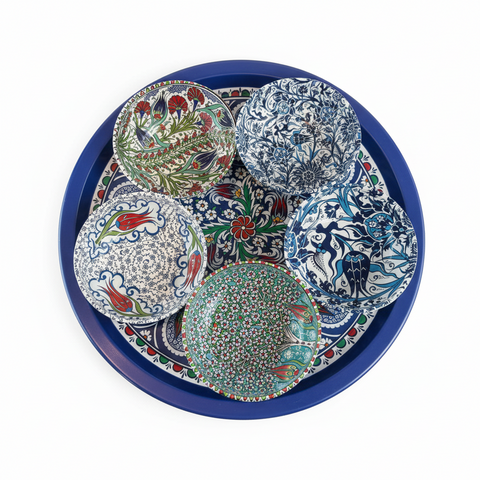 Set of colorful ceramic plates on a blue tray with intricate patterns