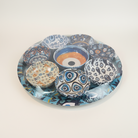 Set of decorative bowls with blue and white patterns on a matching plate.