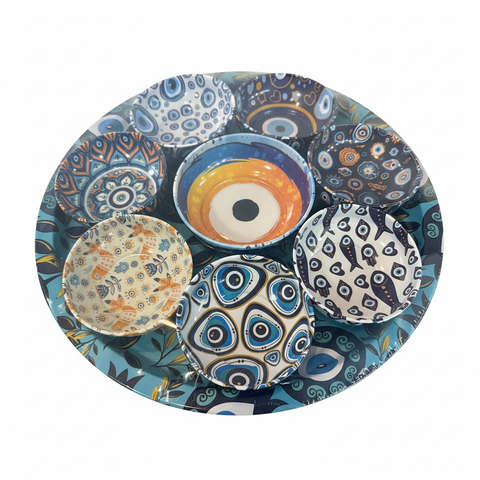 Collection of colorful ceramic plates with various patterns on a white background