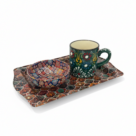 Colorful ceramic mug and bowl set on a decorative tray with a white background