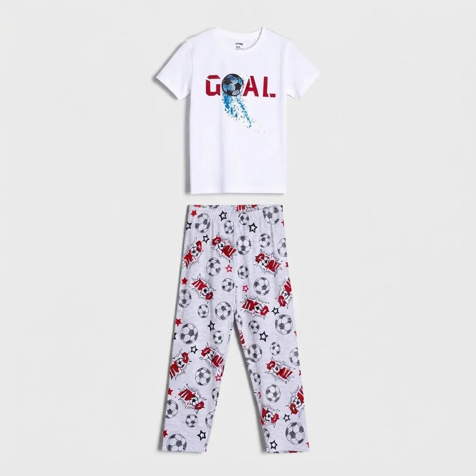 A two-piece kids' pajama set featuring a white short-sleeve t-shirt with a red and blue 'GOAL.' graphic, paired with white leggings covered in a soccer ball print.
