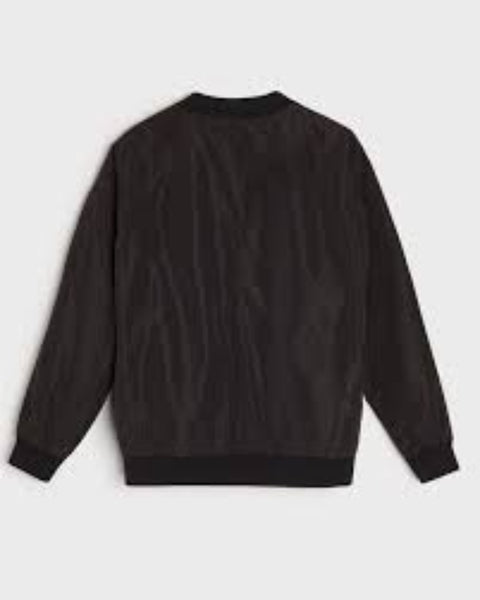 Black sweater on a light gray background