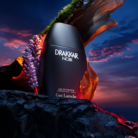 Drakkar Noir perfume bottle with a dramatic sky background