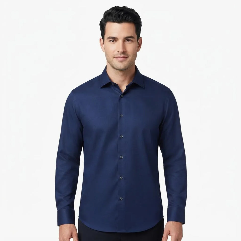 A man wearing a dark navy blue long-sleeve button-down shirt, shown from the waist up against a plain white background.