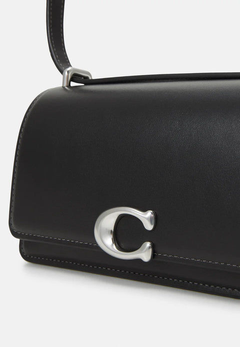 Black handbag with a silver logo on a white background