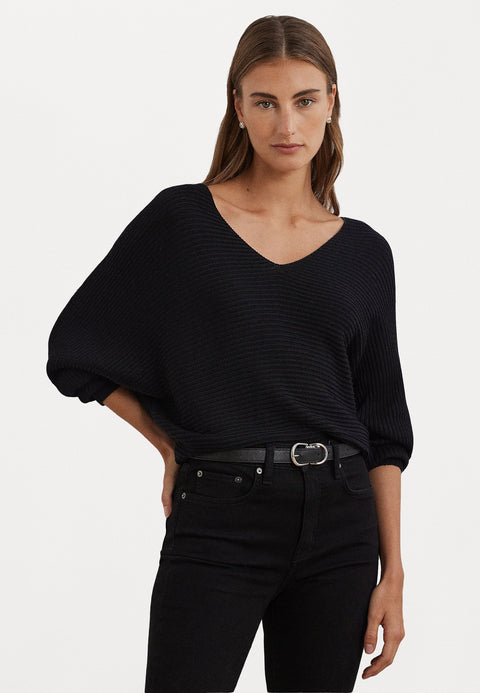 Woman wearing a black sweater and pants on a white background