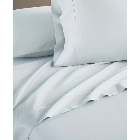 Light blue bedding set with pillows on a neutral background