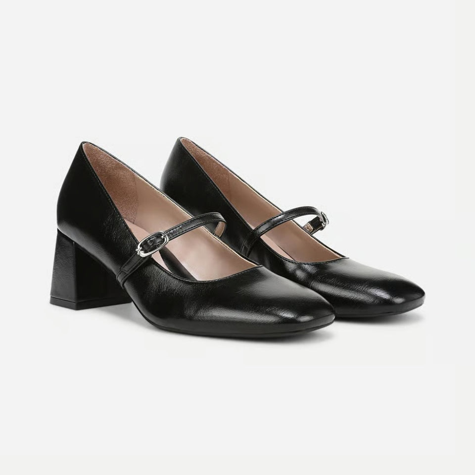 A pair of black leather Mary Jane pumps with block heels and a single silver buckle, displayed on a clean light gray background.
