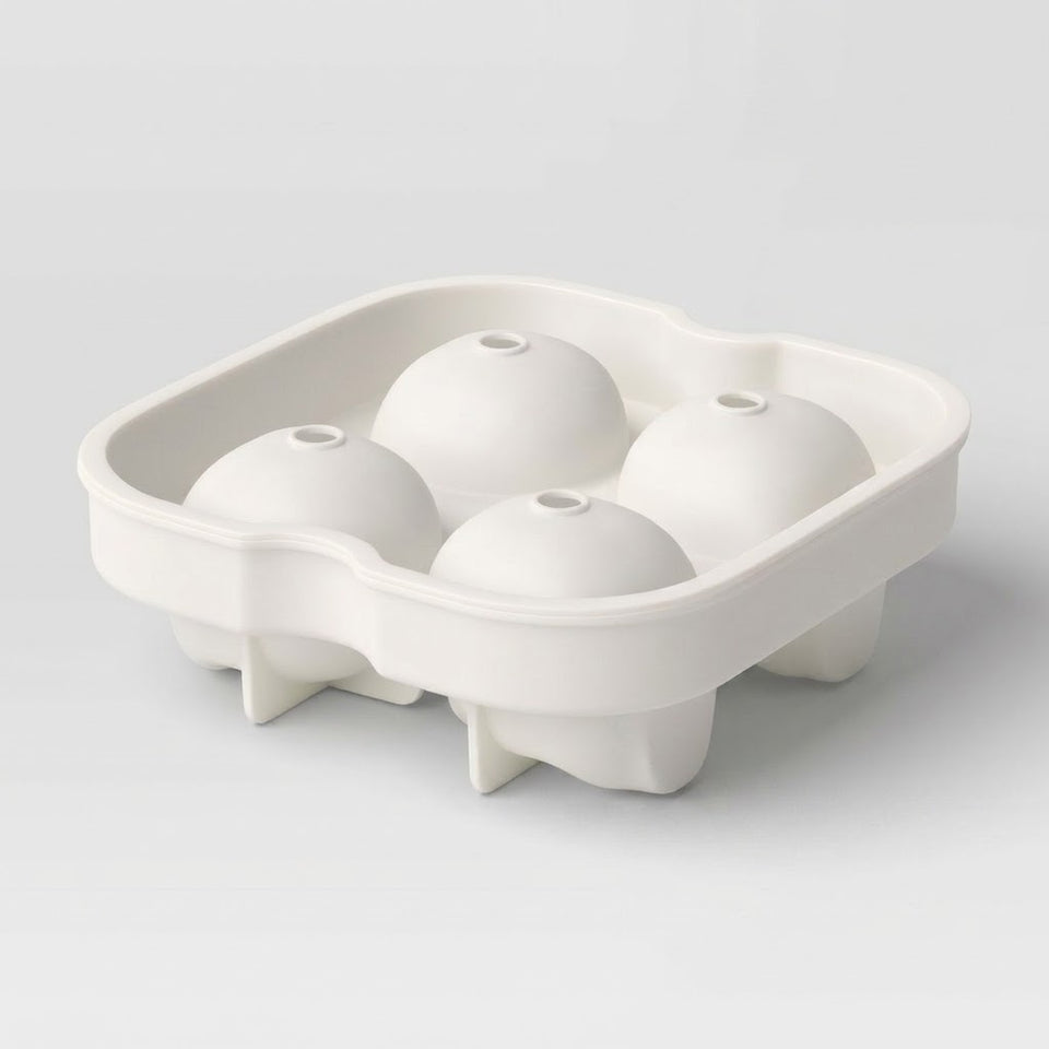 A white silicone mold tray with four oval cavities, shown empty on a light gray studio background.