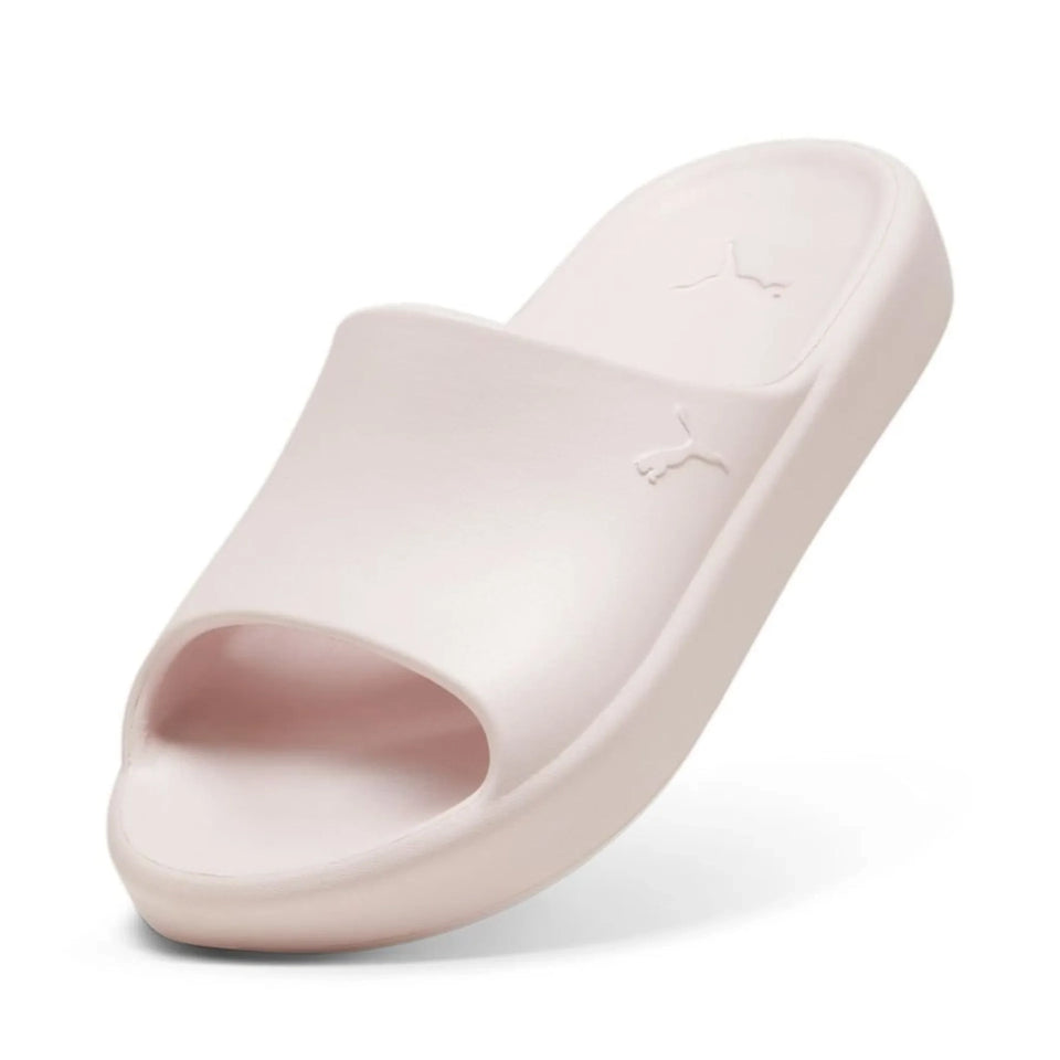 A single Puma slide sandal in a pale pink color, shown from a three-quarters angle on a white background.