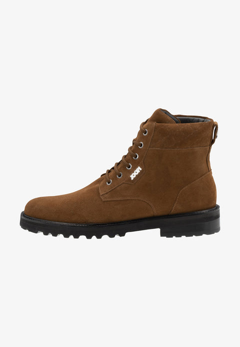 Brown suede boot with black sole on a white background