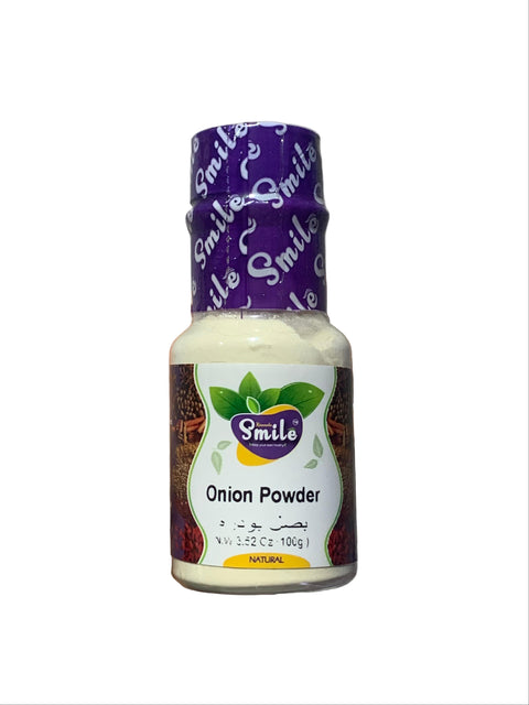 Hand holding a bottle of 'Smile' onion powder against a gray background