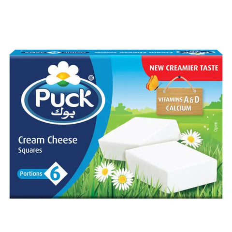 Puck Cream Cheese Squares packaging with grass and daisy background