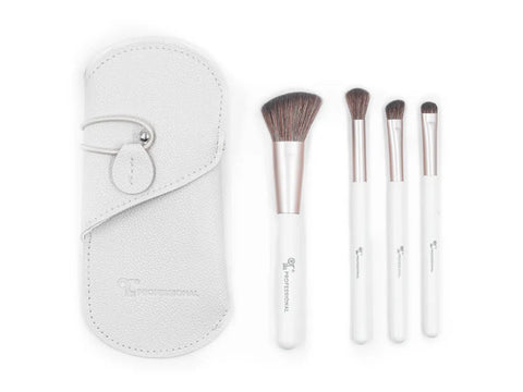 A set of four makeup brushes with white handles and rose gold ferrules, displayed alongside a white carrying case.