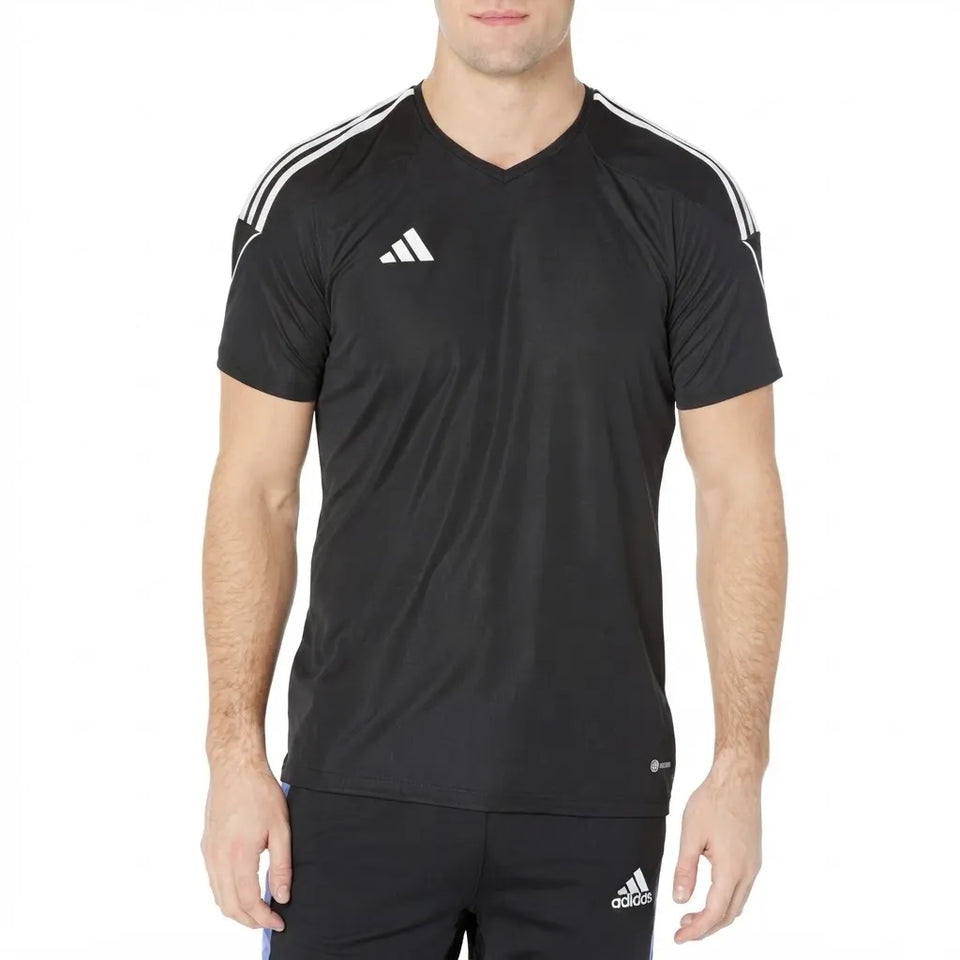 A man wearing a black Adidas athletic t-shirt with white shoulder stripes and a white Adidas logo on the chest, paired with black shorts.
