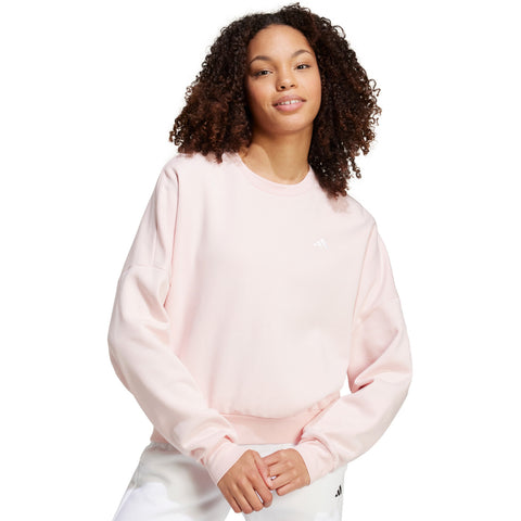 Person wearing a light pink sweatshirt on a white background