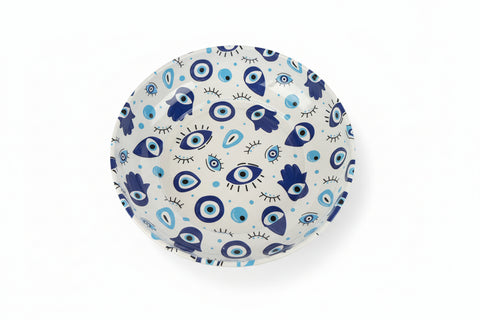 Decorative plate with eye pattern on a wooden surface