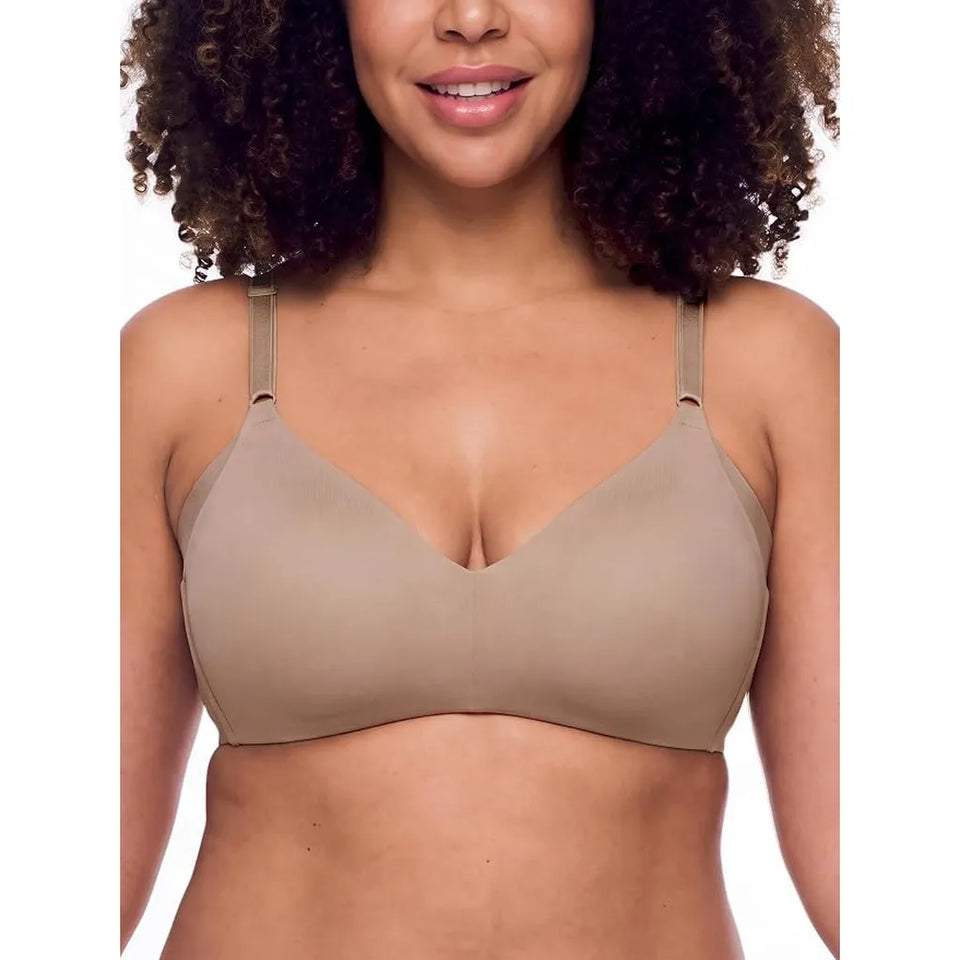 A woman wearing a seamless, underwire bra in a light taupe-beige color, shown from the chest up against a plain white background.