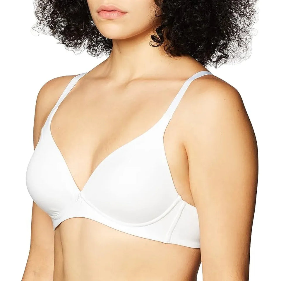 A close-up of a woman wearing a white wireless bra against a plain white background.
