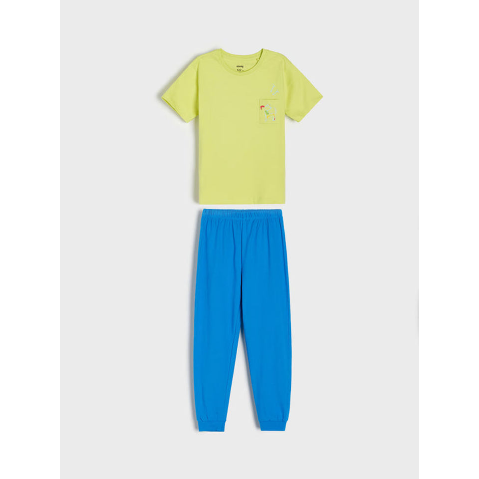 A two-piece kids' pajama set featuring a light yellow-green short-sleeve t-shirt with a small colorful graphic on the left chest, paired with bright blue jogger pants, displayed flat against a light gray background.