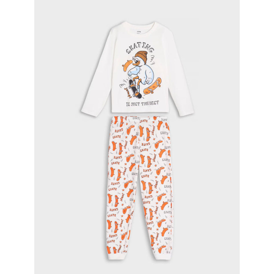 A two-piece children's pajama set on a light gray background. The set includes a white long-sleeve top with a cartoon penguin graphic and the words 'SKATING IS NOT TOGETHER' printed on the front, and white pants covered in an orange and gray penguin pattern.