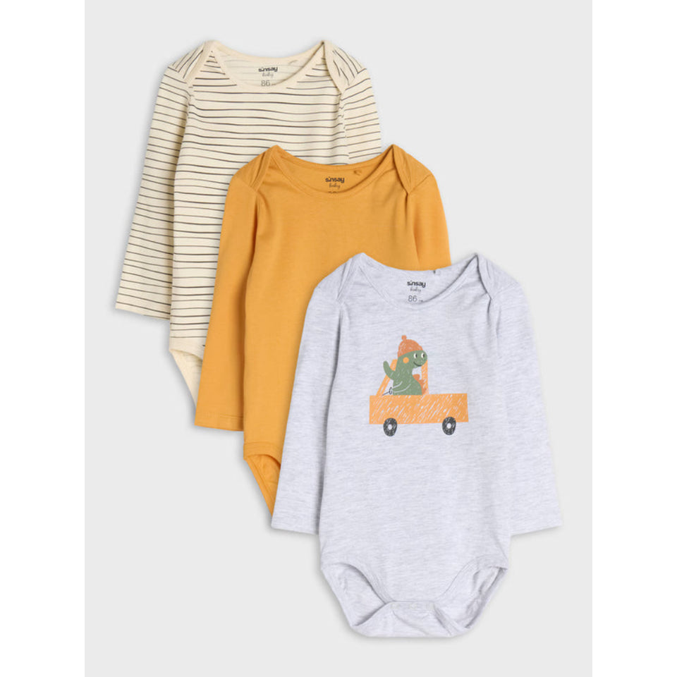 Three long-sleeve baby bodysuits stacked in an overlapping arrangement on a light gray background. The top bodysuit is cream with thin tan stripes, the middle is mustard yellow, and the bottom is light heather gray with a dinosaur in an orange truck graphic.