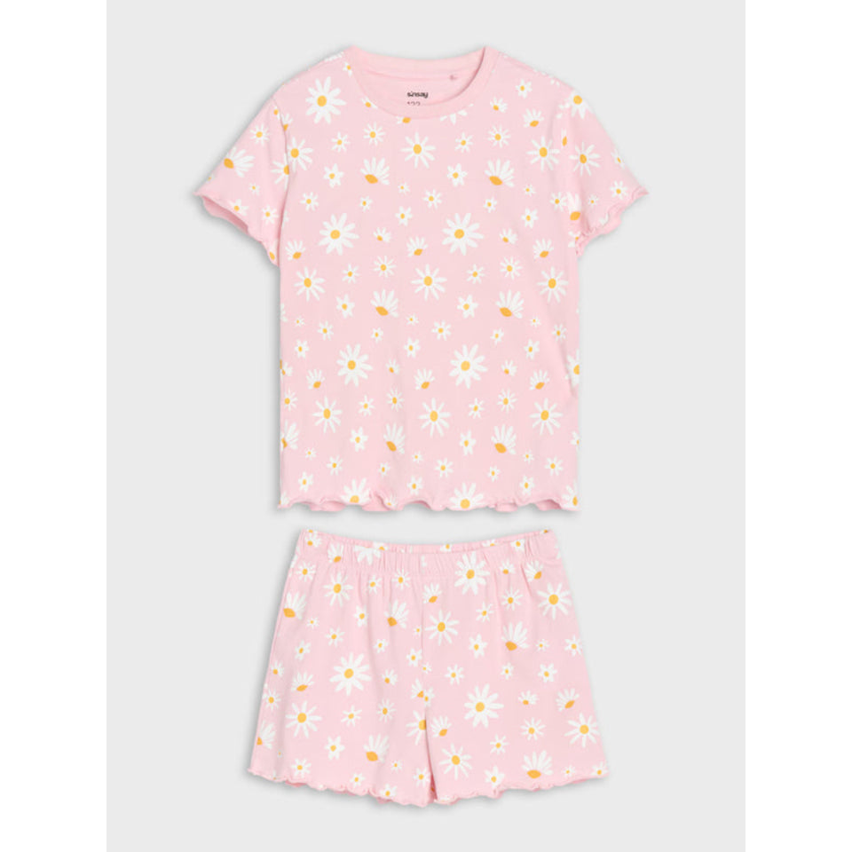A two-piece girls' pajama set featuring a short-sleeve top and matching shorts in light pink, both covered in a white daisy and yellow sunflower print, displayed on a light gray background.
