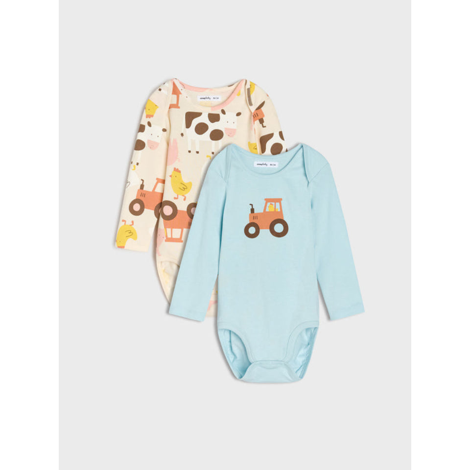 Two long-sleeve baby bodysuits from MAMMA & JUNGO, displayed as a set against a light gray background. The front bodysuit is light blue with an orange tractor graphic on the chest.
